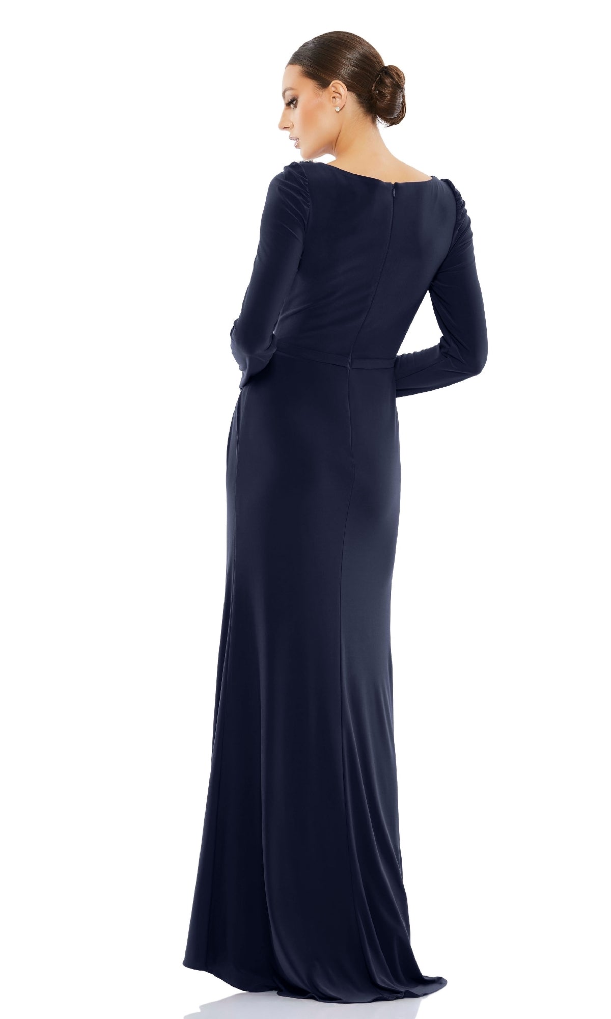 A woman with hair in a bun models the Long Formal Dress 55695 by Mac Duggal—a navy blue, long-sleeved, floor-length high neck gown—shown from the back against a white background.